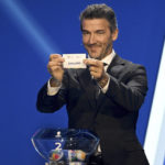 
              Karl-Heinz Riedle, former soccer player and soccer official, holds the lot of  England during the draw for the groups to qualify for the 2024 European soccer championship in Frankfurt, Germany, Sunday, Oct.9, 2022.  (Arne Dedert/dpa via AP)
            