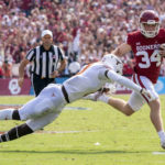 
              Oklahoma kicker Zach Schmit (34) runs for a first down past Texas linebacker DeMarvion Overshown (0) on a fake field goal during the first half of an NCAA college football game at the Cotton Bowl, Saturday, Oct. 8, 2022, in Dallas. (AP Photo/Jeffrey McWhorter)
            