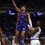 
              Detroit Pistons guard Cade Cunningham (2) drives to the basket past New York Knicks forward Julius Randle during the first half of an NBA basketball game Friday, Oct. 21, 2022, in New York. (AP Photo/Adam Hunger)
            