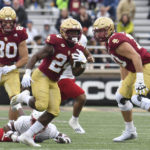 
              Boston College running back Pat Garwo eludes a Louisville defenseman during the first half of an NCAA college football game, Saturday, Oct. 1, 2022, in Boston. (AP Photo/Mark Stockwell)
            