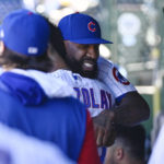 
              Chicago Cubs' Jason Heyward, right, is hugged by starting pitcher Adbert Alzolay after being honored during the team's baseball game against the Cincinnati Reds in Chicago, Saturday, Oct. 1, 2022. (AP Photo/Matt Marton)
            