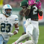 
              South Florida running back Michel Dukes (2) pulls in a reception after getting around Tulane safety Lummie Young IV (23) during the second half of an NCAA college football game Saturday, Oct. 15, 2022, in Tampa, Fla. (AP Photo/Chris O'Meara)
            