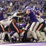 
              Minnesota Vikings quarterback Kirk Cousins, center, scores on a 1-yard touchdown run during the second half of an NFL football game against the Chicago Bears, Sunday, Oct. 9, 2022, in Minneapolis. (AP Photo/Abbie Parr)
            