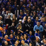 
              A New York Rangers fan, lower left, holds a giant bread loaf toy during the second period of an NHL hockey game against the Anaheim Ducks, Monday, Oct. 17, 2022, in New York. (AP Photo/Julia Nikhinson)
            