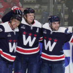 
              Washington Capitals center Evgeny Kuznetsov (92), defenseman John Carlson (74) and left wing Conor Sheary (73) celebrate a goal during the third period of an NHL hockey game against the Vancouver Canucks, Monday, Oct. 17, 2022, in Washington. (AP Photo/Jess Rapfogel)
            