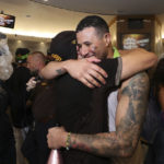 
              San Diego Padres' Manny Machado hugs a teammate after clinching a wild-card playoff spot following a baseball game against the Chicago White Sox, Sunday, Oct. 2, 2022, in San Diego. (AP Photo/Derrick Tuskan)
            