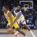 
              Golden State Warriors forward Andrew Wiggins, right, tries to pokes the ball away from Los Angeles Lakers guard Lonnie Walker IV (4) during the second half of an NBA preseason basketball game in San Francisco, Sunday, Oct. 9, 2022. (AP Photo/Godofredo A. Vásquez)
            