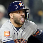 
              Houston Astros' Jose Altuve reacts as he connects for a base hit against the New York Yankees during the fifth inning of Game 3 of an American League Championship baseball series, Saturday, Oct. 22, 2022, in New York. (AP Photo/John Minchillo)
            