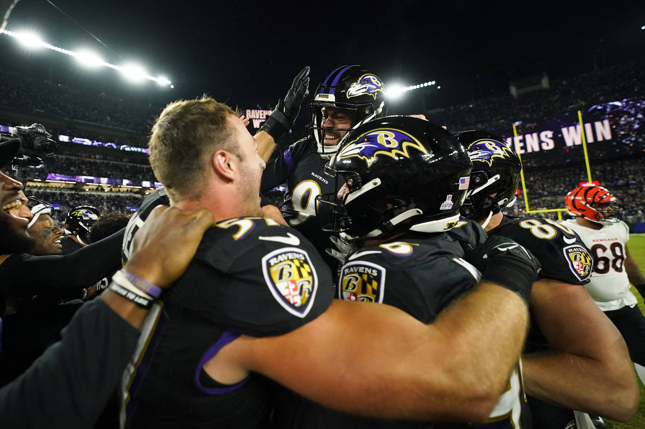 Baltimore Ravens place kicker Justin Tucker celebrates with teammates after they defeated the Cinci...
