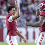 
              Alabama quarterback Bryce Young greets quarterback Jalen Milroe after Milroe's touchdown pass during the first half of an NCAA college football game, Saturday, Oct. 8, 2022, in Tuscaloosa, Ala. (AP Photo/Vasha Hunt)
            