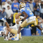 
              UCLA wide receiver Logan Loya (17) is tackled by Stanford wide receiver Brycen Tremayne (81) on a punt return during the first half of an NCAA college football game in Pasadena, Calif., Saturday, Oct. 29, 2022. Loya fumbled the ball and it was recovered by Stanford tight end Sam Roush (86). (AP Photo/Ashley Landis)
            