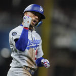 
              Los Angeles Dodgers' Mookie Betts reacts after hitting a sacrifice fly during the fifth inning in Game 3 of a baseball NL Division Series against the San Diego Padres, Friday, Oct. 14, 2022, in San Diego. Los Angeles Dodgers' Trayce Thompson scored on the play. (AP Photo/Ashley Landis)
            