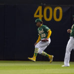 
              Oakland Athletics center fielder Cristian Pache (20) runs down Los Angeles Angels' Taylor Ward's RBI double during the fifth inning of a baseball game, Monday, Oct. 3, 2022, in Oakland, Calif. (AP Photo/D. Ross Cameron)
            