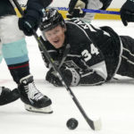 
              Los Angeles Kings right wing Arthur Kaliyev, right, falls as Seattle Kraken defenseman Vince Dunn takes the puck during the second period of an NHL hockey game Thursday, Oct. 13, 2022, in Los Angeles. (AP Photo/Mark J. Terrill)
            