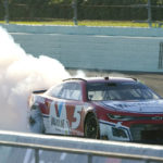 
              Kyle Larson (5) does a burnout after winning a NASCAR Cup Series auto race at Homestead-Miami Speedway, Sunday, Oct. 23, 2022, in Homestead, Fla. (AP Photo/Lynne Sladky)
            