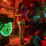 
              A woman sings at "The Irish Pub," which will be one of the bars showing World Cup 2022 matches on live screens, in Doha, Qatar, Thursday, Oct. 20, 2022. (AP Photo/Nariman El-Mofty)
            