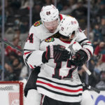 
              Chicago Blackhawks center Sam Lafferty (24) celebrates with Jason Dickinson (17) after scoring against the San Jose Sharks during the second period of an NHL hockey game in San Jose, Calif., Saturday, Oct. 15, 2022. (AP Photo/Godofredo A. Vásquez)
            