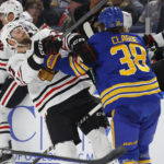 
              Chicago Blackhawks center Jason Dickinson (17) and Buffalo Sabres defenseman Kale Clague (38) collide during the second period of an NHL hockey game, Saturday, Oct. 29, 2022, in Buffalo, N.Y. (AP Photo/Jeffrey T. Barnes)
            