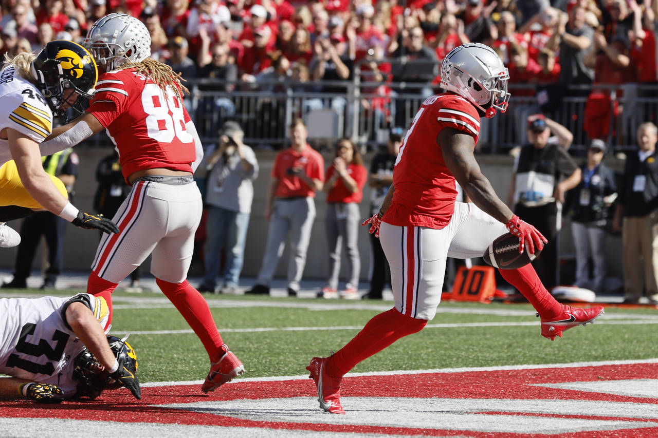 Ohio State running back Miyan Williams, right, scores a touchdown against Iowa during the first hal...