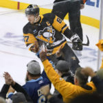 
              Fans cheer as Sidney Crosby celebrates his goal during the first period of the team's NHL hockey game against the Arizona Coyotes, Thursday, Oct. 13, 2022, in Pittsburgh. (AP Photo/Keith Srakocic)
            