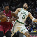 
              Miami Heat forward Jimmy Butler (22) drives to the basket as Boston Celtics forward Jayson Tatum (0) defends during the first half of an NBA game Friday, Oct. 21, 2022, in Miami. (AP Photo/Marta Lavandier)
            