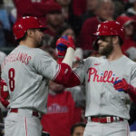 
              Philadelphia Phillies' Bryce Harper celebrates with Nick Castellanos (8) after Harper hit a solo home run against the St. Louis Cardinals during the second inning in Game 2 of an NL wild-card baseball playoff series, Saturday, Oct. 8, 2022, in St. Louis. (AP Photo/Jeff Roberson)
            