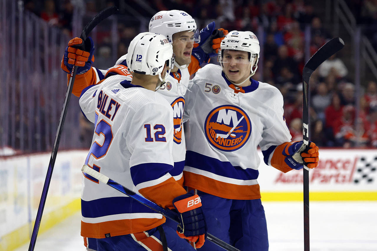 New York Islanders' Oliver Wahlstrom (26) is congratulated on his goal by teammates Josh Bailey (12...