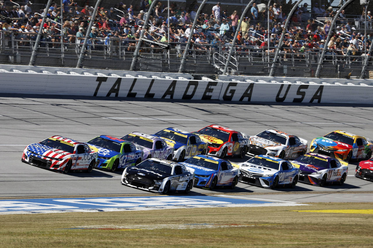 Ross Chastain (1) leads a pack of cars to through the Tai-Oval during a NASCAR Cup Series auto race...