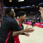 
              Portland Trail Blazers guard Anfernee Simons, center, and forward Nassir Little celebrate after an NBA basketball game against the Phoenix Suns in Portland, Ore., Friday, Oct. 21, 2022. (AP Photo/Craig Mitchelldyer)
            