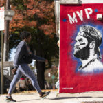 
              A person walks past a mural of Philadelphia Phillies designated hitter Bryce Harper, created by artist Nero, in Philadelphia, Thursday, Oct. 27, 2022. Game 1 of baseball's World Series between the Phillies and Houston Astros is Friday in Houston. (AP Photo/Matt Rourke)
            