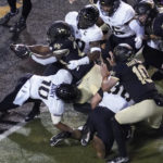 
              Wake Forest running back Quinton Cooley (28) stretches the ball over the goal line for a touchdown against Army during the first half of an NCAA college football game in Winston-Salem, N.C., Saturday, Oct. 8, 2022. (AP Photo/Chuck Burton)
            