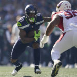 
              Seattle Seahawks running back Kenneth Walker III (9) runs against Arizona Cardinals defensive tackle Rashard Lawrence (90) during the first half of an NFL football game in Seattle, Sunday, Oct. 16, 2022. (AP Photo/Abbie Parr)
            