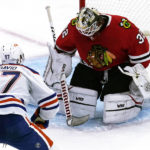 
              Chicago Blackhawks goaltender Alex Stalock, right, can't stop a goal by Edmonton Oilers center Connor McDavid during the third period of an NHL hockey game in Chicago, Thursday, Oct. 27, 2022. The Oilers won 6-5. (AP Photo/Nam Y. Huh)
            