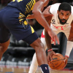 
              Brooklyn Nets guard Kyrie Irving looks for help against Indiana Pacers guard Buddy Hield during the second half of an NBA basketball game, Saturday, Oct. 29, 2022, in New York. (AP Photo/Noah K. Murray)
            