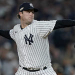 
              New York Yankees starting pitcher Gerrit Cole delivers against the Cleveland Guardians during the first inning of Game 1 of an American League Division baseball series, Tuesday, Oct. 11, 2022, in New York. (AP Photo/John Minchillo)
            