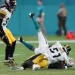 
              Pittsburgh Steelers linebacker Myles Jack (51) slams Miami Dolphins wide receiver Jaylen Waddle (17) to the ground during the second half of an NFL football game, Sunday, Oct. 23, 2022, in Miami Gardens, Fla. (AP Photo/Wilfredo Lee )
            
