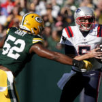 
              New England Patriots quarterback Brian Hoyer (5) is sacked by Green Bay Packers linebacker Rashan Gary (52) during the first half of an NFL football game, Sunday, Oct. 2, 2022, in Green Bay, Wis. (AP Photo/Morry Gash)
            
