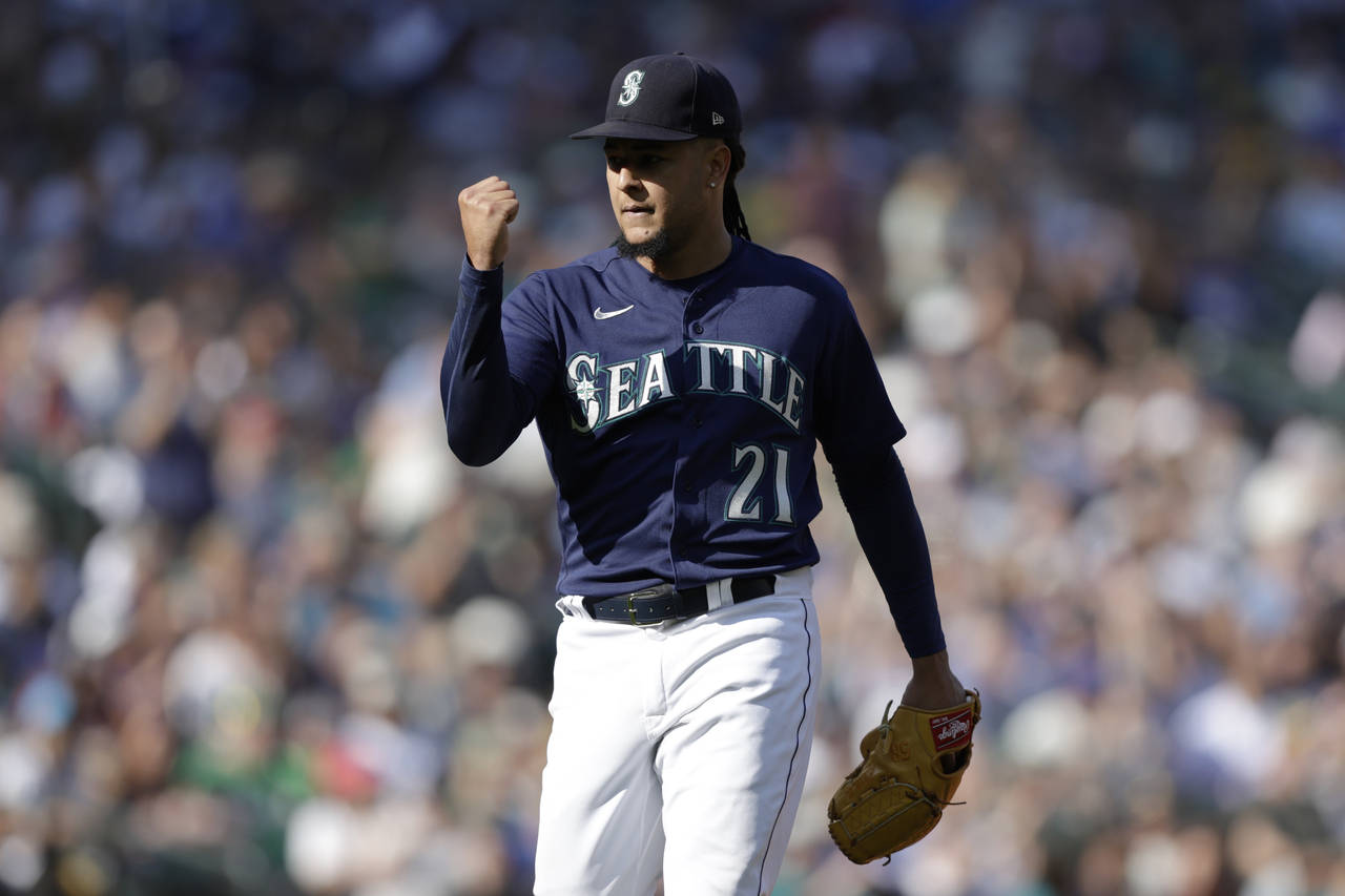 Seattle Mariners starting pitcher Luis Castillo pumps his fist after pitching against the Oakland A...