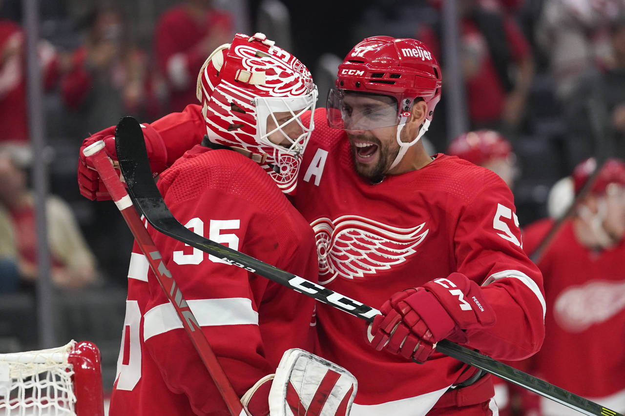 Detroit Red Wings goaltender Ville Husso (35) and David Perron (57) celebrate after beating the Ana...
