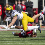 
              Michigan tight end Luke Schoonmaker (86) is knocked off his feet by Indiana defensive back Bryant Fitzgerald (31) during the first half of an NCAA college football game, Saturday, Oct. 8, 2022, in Bloomington, Ind. (AP Photo/Doug McSchooler)
            
