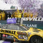 
              Christopher Bell (20) celebrates in Victory Lane after winning a NASCAR Cup Series auto race at Martinsville Speedway, Sunday, Oct. 30, 2022, in Martinsville, Va. (AP Photo/Chuck Burton)
            