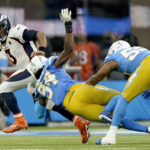 
              Denver Broncos quarterback Russell Wilson (3) is hurried by Los Angeles Chargers linebacker Chris Rumph II (94) during the first half of an NFL football game, Monday, Oct. 17, 2022, in Inglewood, Calif. (AP Photo/Mark J. Terrill)
            