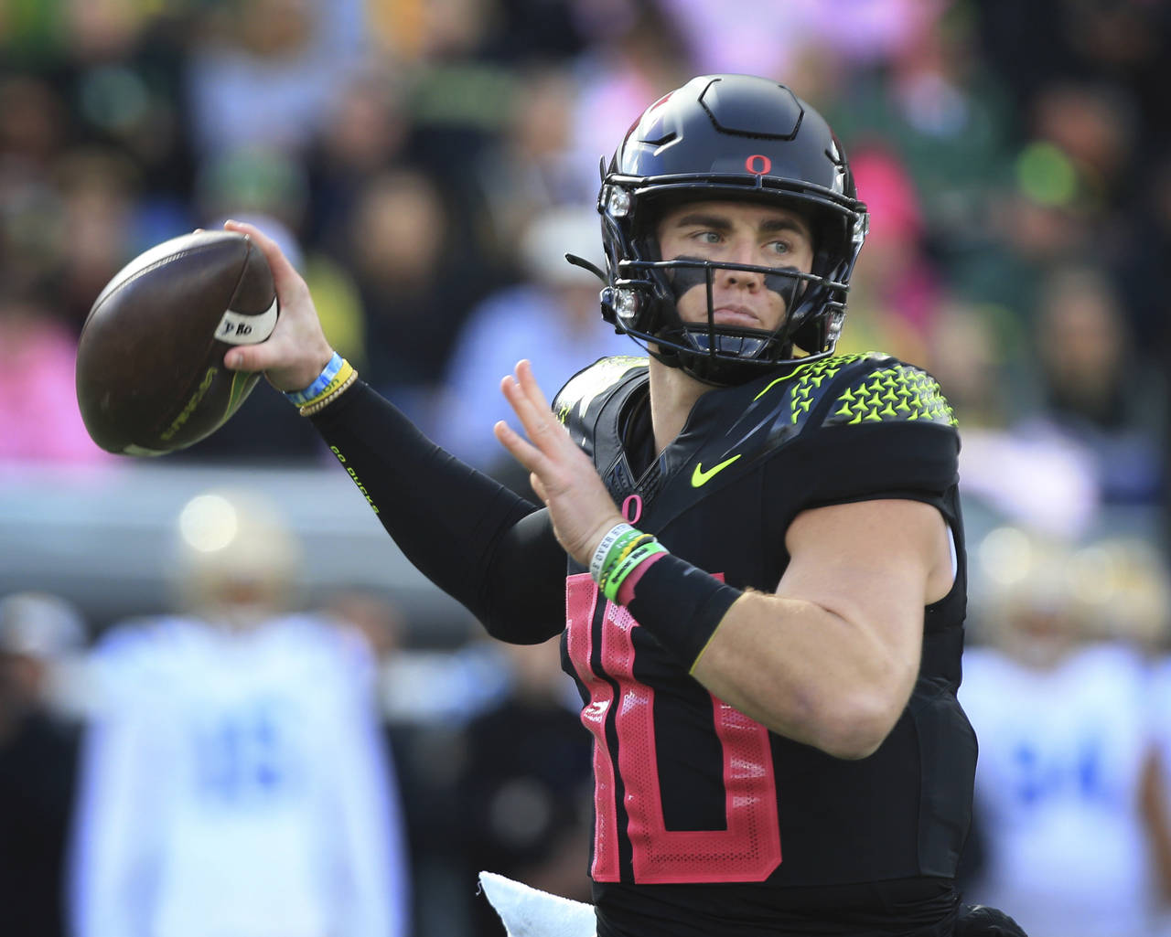 Oregon's Bo Nix throws down field against UCLA during the first half in an NCAA college football ga...