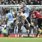 
              Manchester City's Erling Haaland, center, heads the ball to score his side's second goal during the English Premier League soccer match between Manchester City and Manchester United at Etihad stadium in Manchester, England, Sunday, Oct. 2, 2022. (AP Photo/Rui Vieira)
            