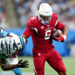 
              Arizona Cardinals running back James Conner breaks away from Carolina Panthers cornerback Jaycee Horn during the second half of an NFL football game on Sunday, Oct. 2, 2022, in Charlotte, N.C. (AP Photo/Jacob Kupferman)
            