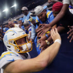 
              Los Angeles Chargers quarterback Justin Herbert (10) acknowledges fans after an NFL football game against the Houston Texans, Sunday, Oct. 2, 2022, in Houston. (AP Photo/David J. Phillip)
            