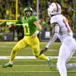 
              Oregon quarterback Bo Nix (10) looks for a receiver as Stanford cornerback Kyu Blu Kelly (17) defends during the first half of an NCAA college football game Saturday, Oct. 1, 2022, in Eugene, Ore. (AP Photo/Andy Nelson)
            