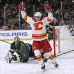 
              FILE - Calgary Flames left wing Johnny Gaudreau celebrates his goal on Minnesota Wild goalie Cam Talbot during the second period of an NHL hockey game April 28, 2022, in St. Paul, Minn. The Columbus Blue Jackets pulled off the improbable, landing the hottest free agent on the market in Gaudreau. He was lured to Columbus with a seven-year deal worth $9.75 million a season and the prospect of playing closer to his New Jersey home. (AP Photo/Craig Lassig, File)
            