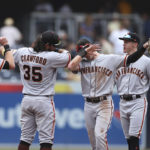 
              San Francisco Giants' Brandon Crawford (35) and Mike Yastrzemski, second from right, celebrate after the team defeated the San Diego Padres in a baseball game, Wednesday, Oct. 5, 2022, in San Diego. (AP Photo/Derrick Tuskan)
            