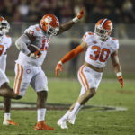 
              Clemson defensive tackle Tyler Davis (13) celebrates his fumble recovery with safety R.J. Mickens (9) and linebacker Keith Maguire (30) during the second quarter of the team's NCAA college football game against Florida State on Saturday, Oct. 15, 2022, in Tallahassee, Fla. (AP Photo/Phil Sears)
            